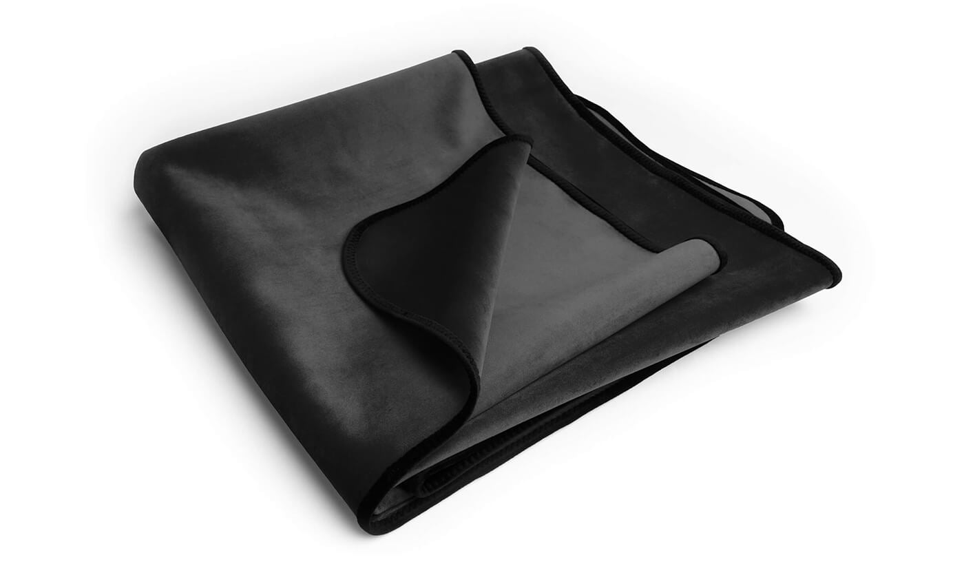 Black fascinator throw made of microvelvet by Liberator, designed for BDSM, in regular size, shown with textured fabric detail.