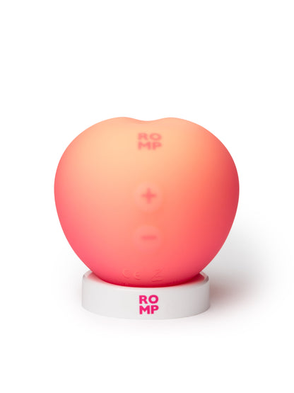 ROMP Pink Peach vibrator shown, featuring smooth silicone surface and ergonomic design for versatile pleasure.
