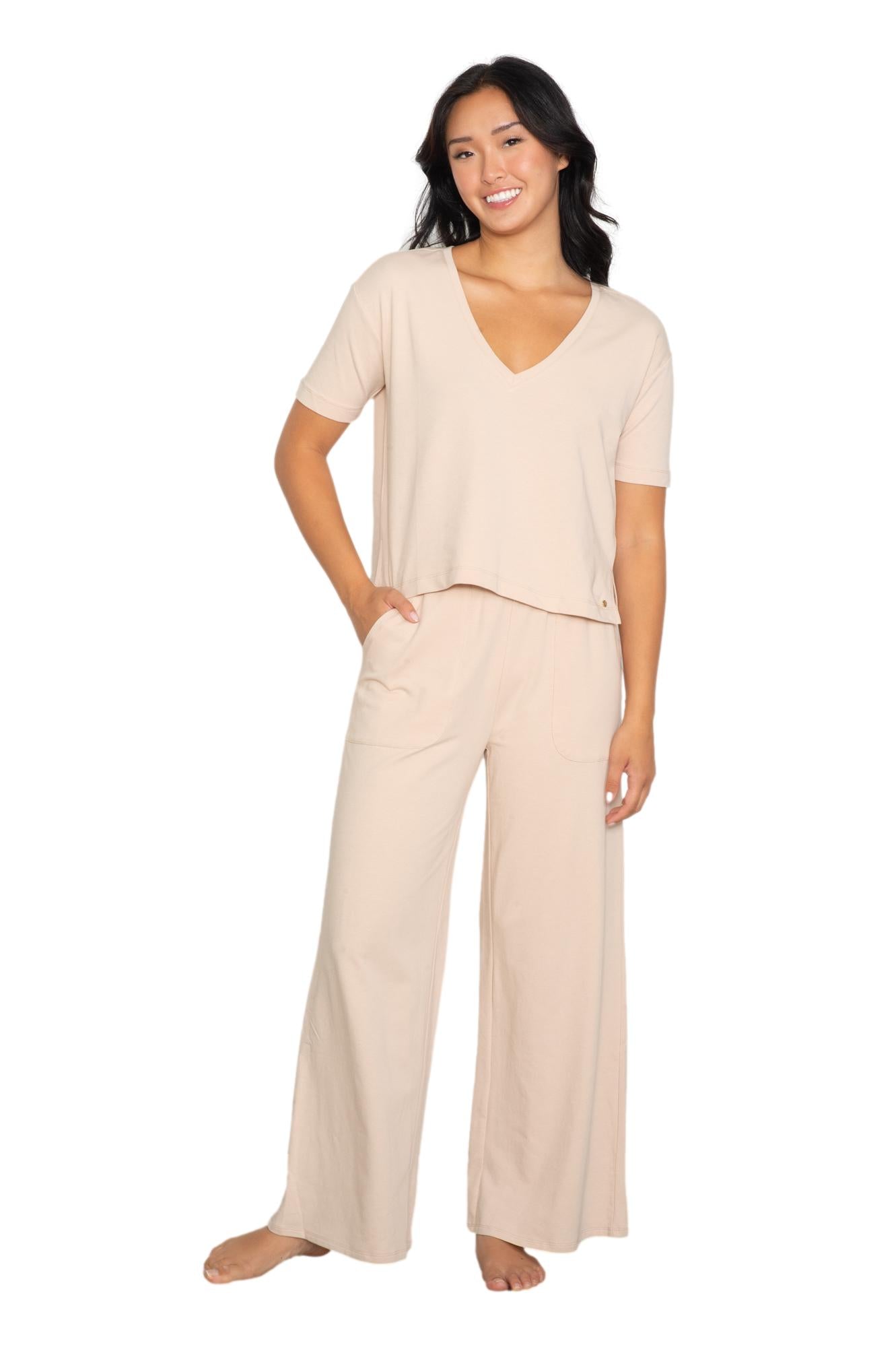 Anastasia's Bedroom Lingerie V-neck tee and wide-leg lounge pant set displayed on a hanger with soft fabric textures.