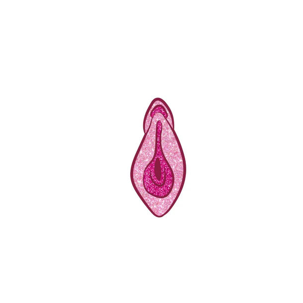 Sparkly pink vulva enamel pin from Anastasia's Bedroom Lingerie, featuring a detailed, glittery design on a metal backing.