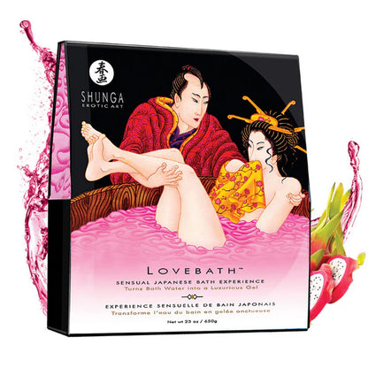Pink sensual bath beads from Anastasia's Bedroom Lingerie displayed in a clear glass bowl on a soft fabric surface.