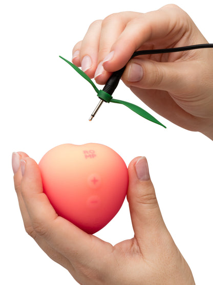 ROMP Pink Peach vibrator shown with smooth, curved design in soft pink color, designed for intimate pleasure.