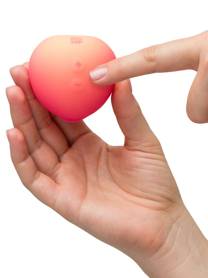 Pink Peach ROMP vibrator with smooth, curved design and textured surface for enhanced pleasure.