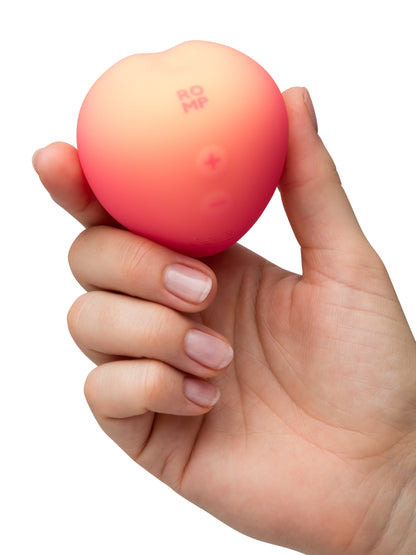 ROMP Pink Peach vibrator with smooth, curved design and textured surface, ideal for personal pleasure and stimulation.